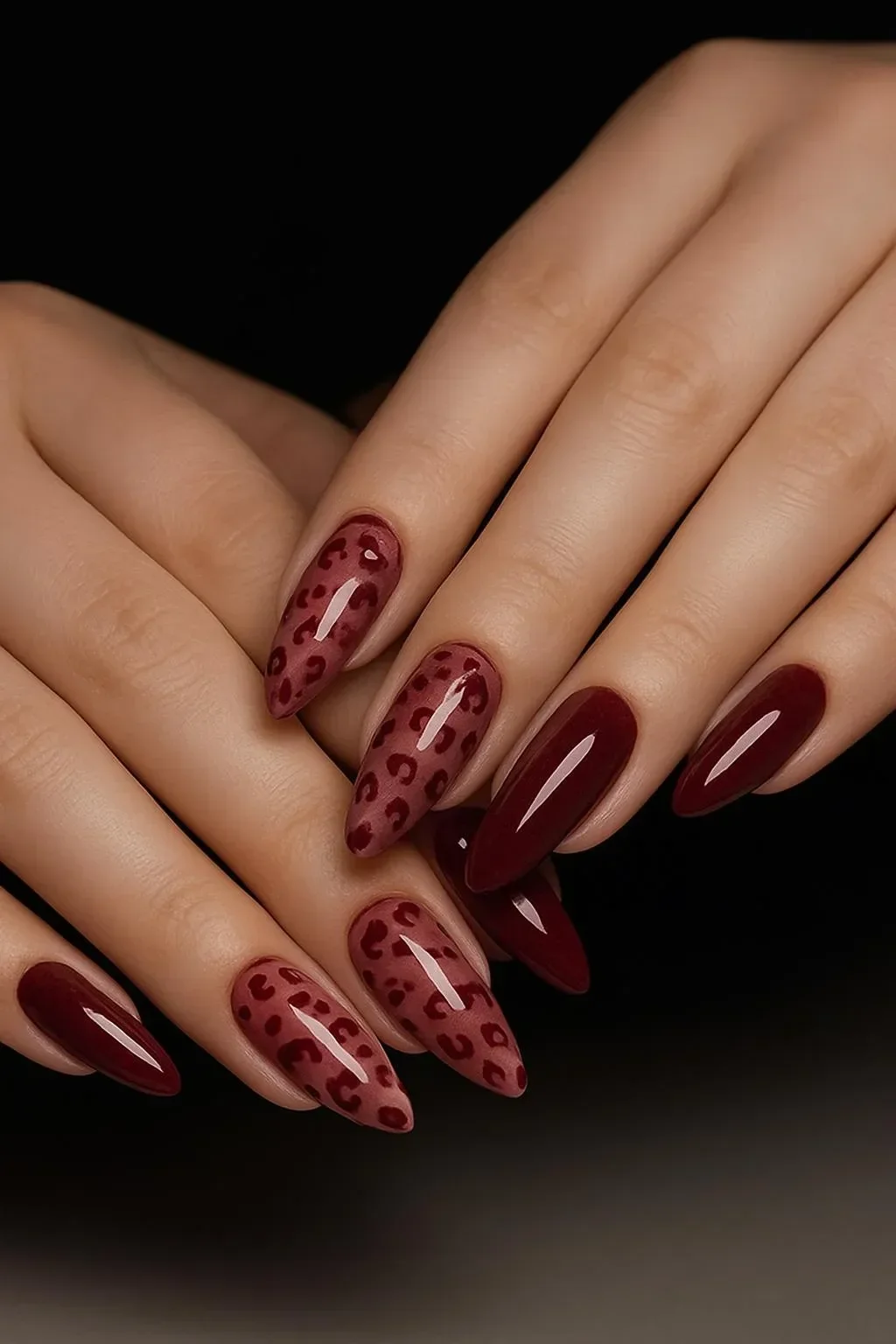 Burgundy leopard print almond nails with a stylish design