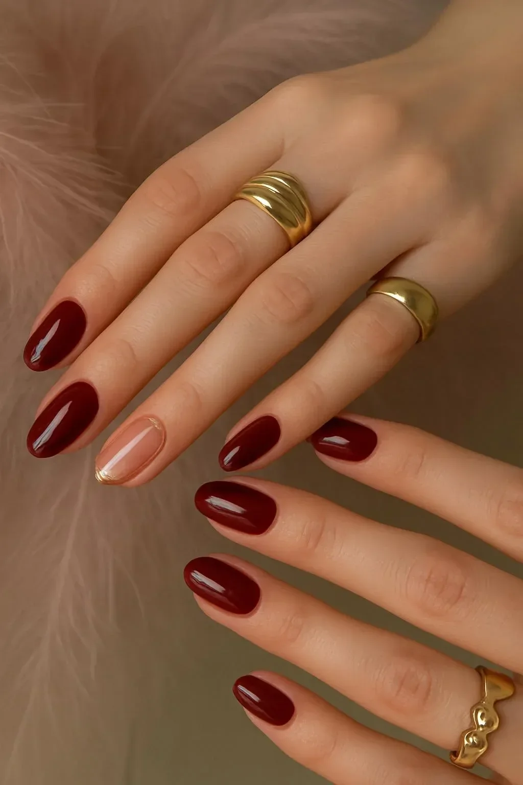 Burgundy nails with liquid gold accents and 3D metallic art design.