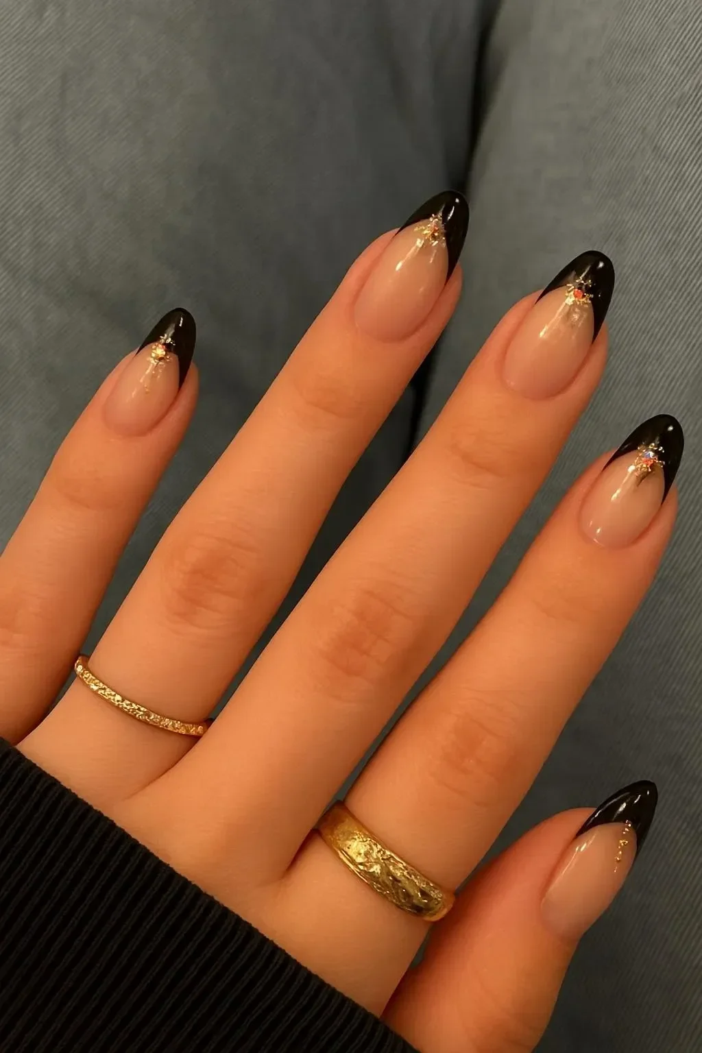 Celestial black French tips nail art with ruby accents design