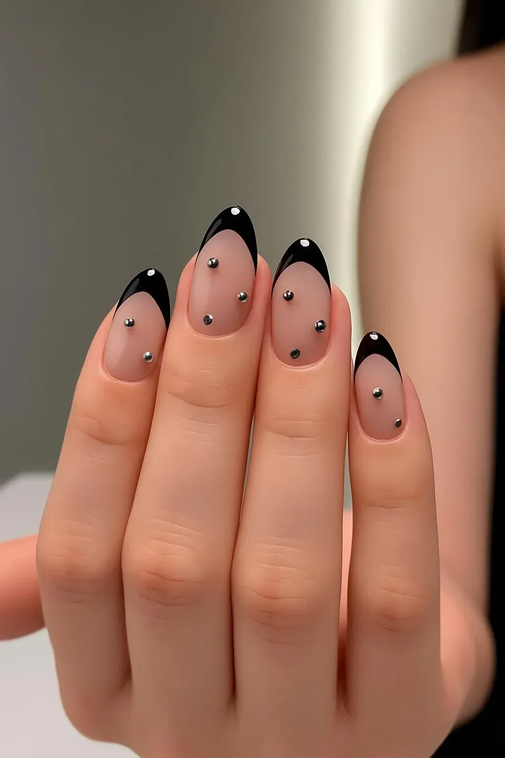 Chic black French tip almond nails with elegant rhinestones for a stylish look