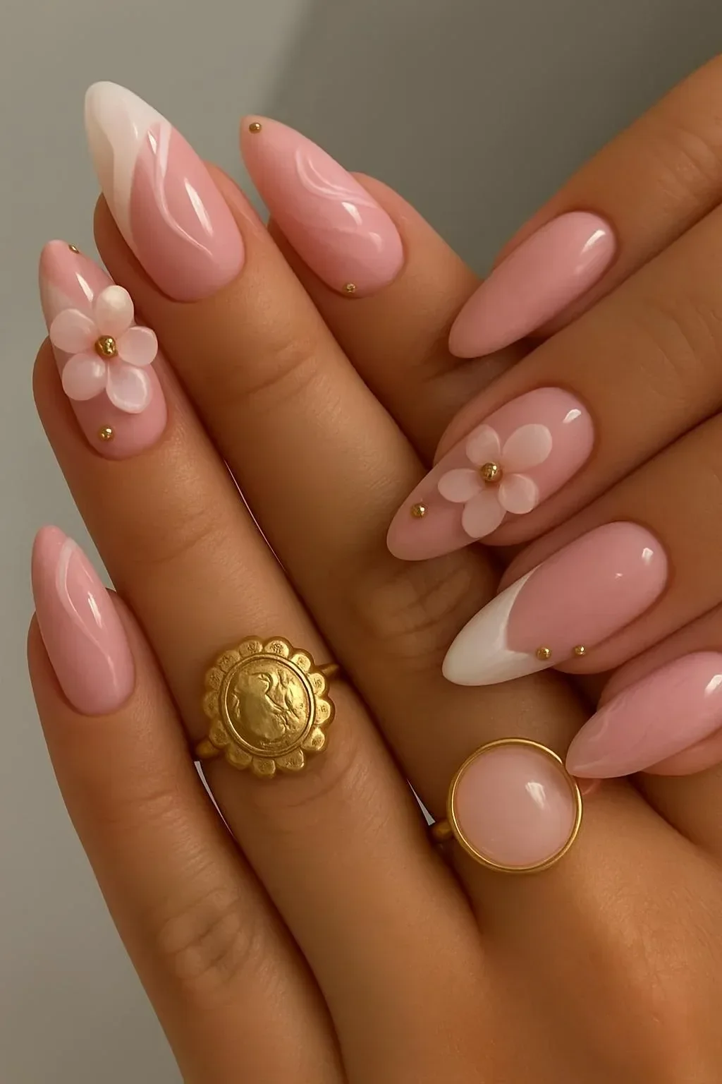 Elegant 3D floral French nails design in pink and white on almond-shaped nails.