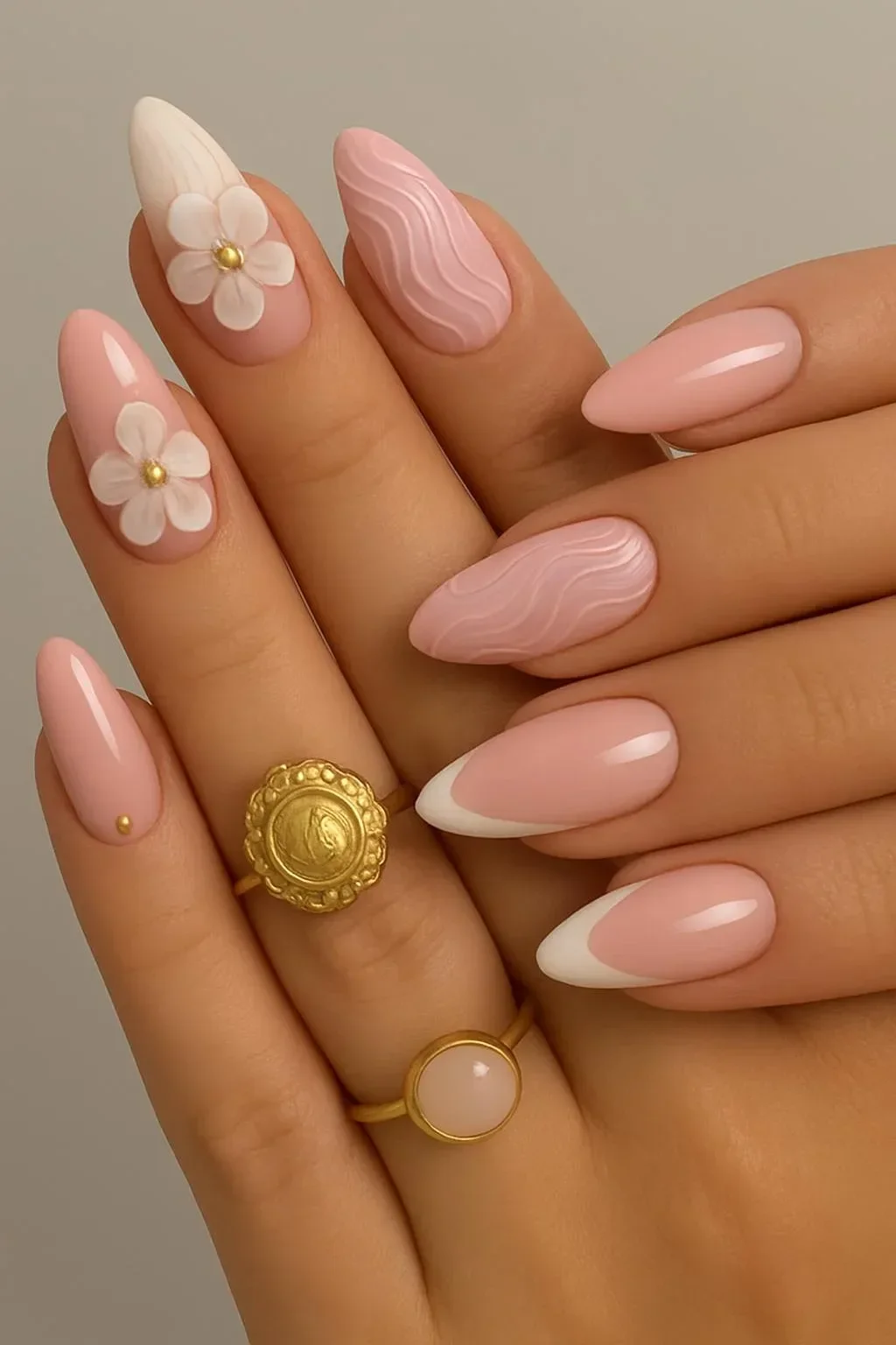 Elegant 3D floral French nails design in pink and white on almond-shaped nails.