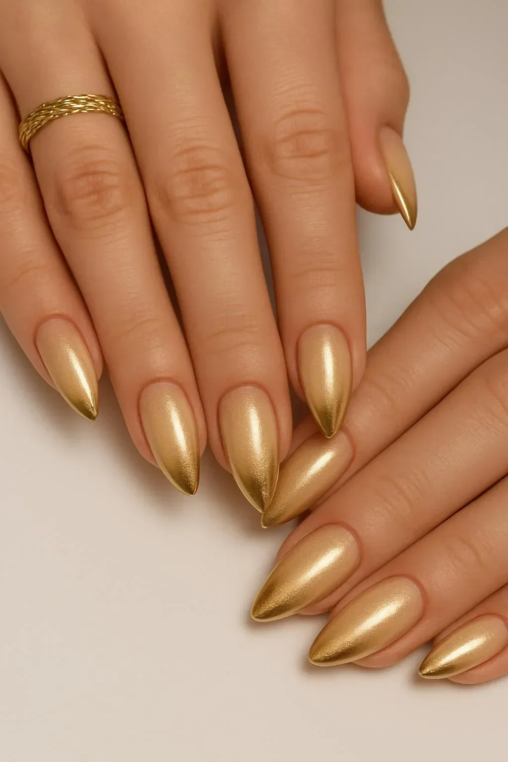 Gold chrome almond nails with stylish outline detail design