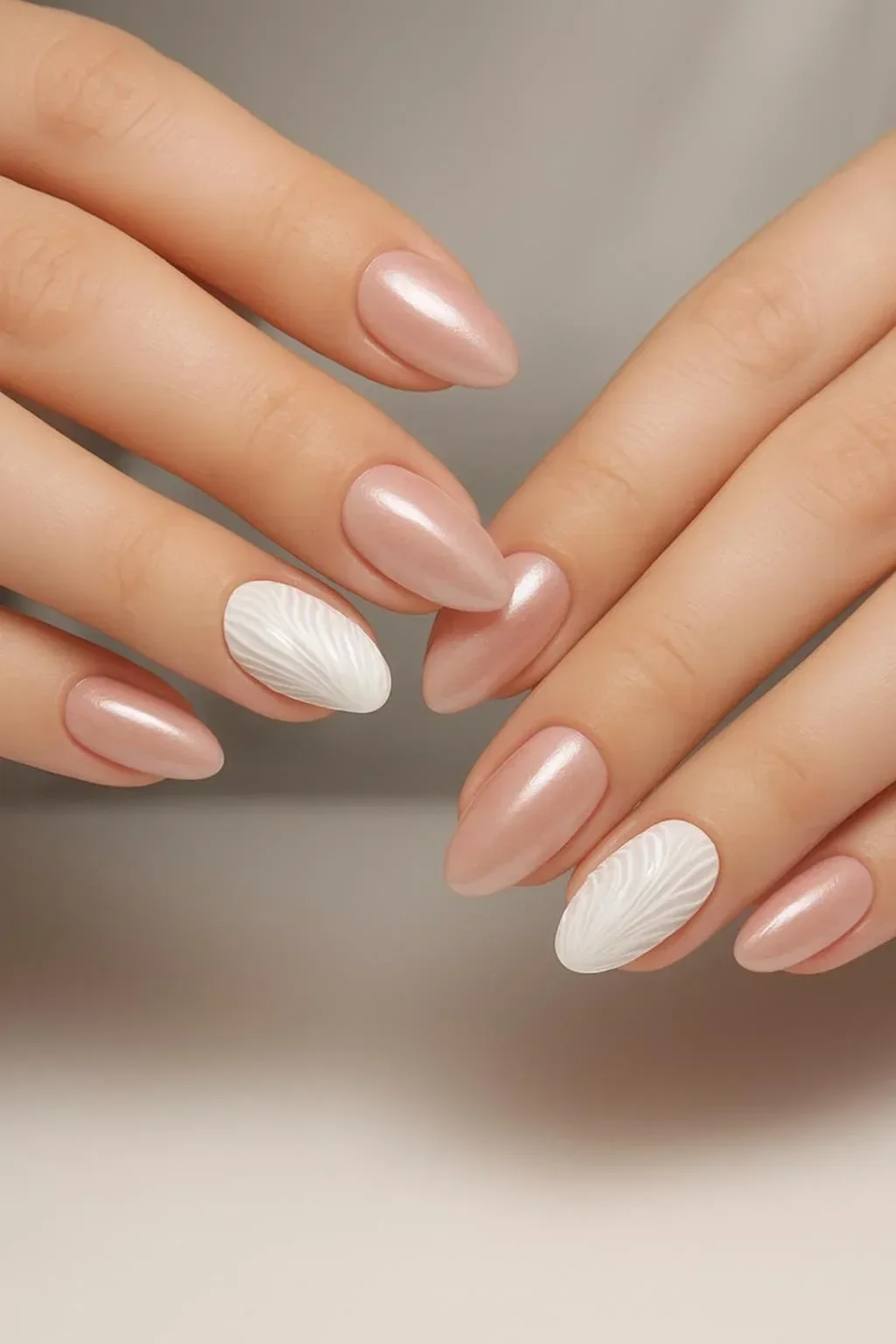 Nude chrome nails featuring an elegant white shell design