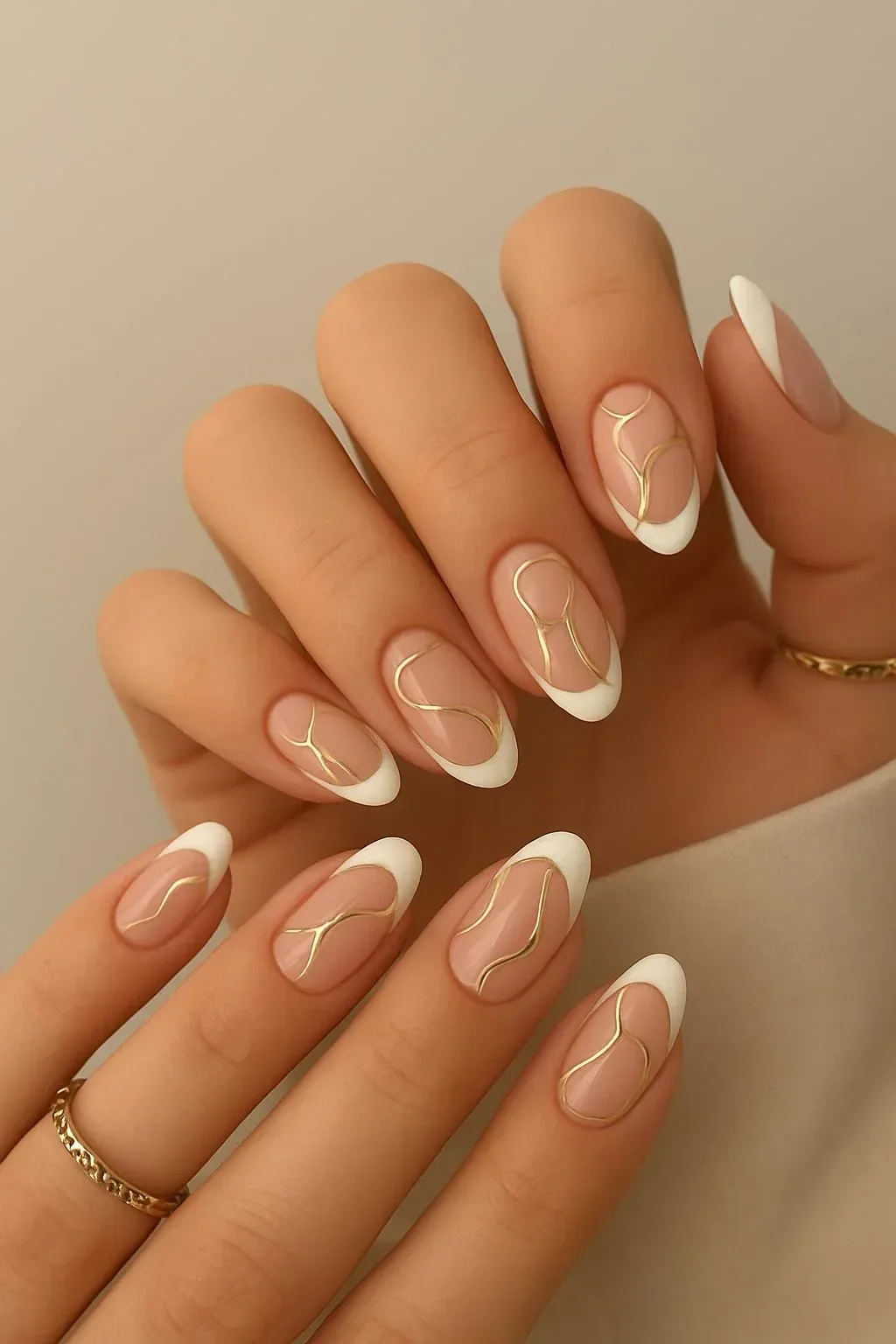 Elegant white French tips with gold abstract swirls on nails
