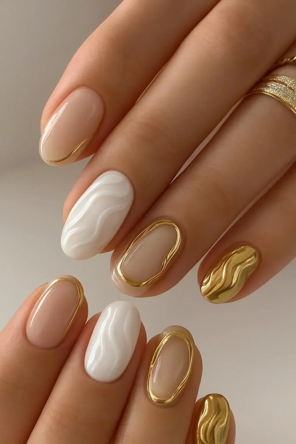 White and gold abstract swirl almond nails design