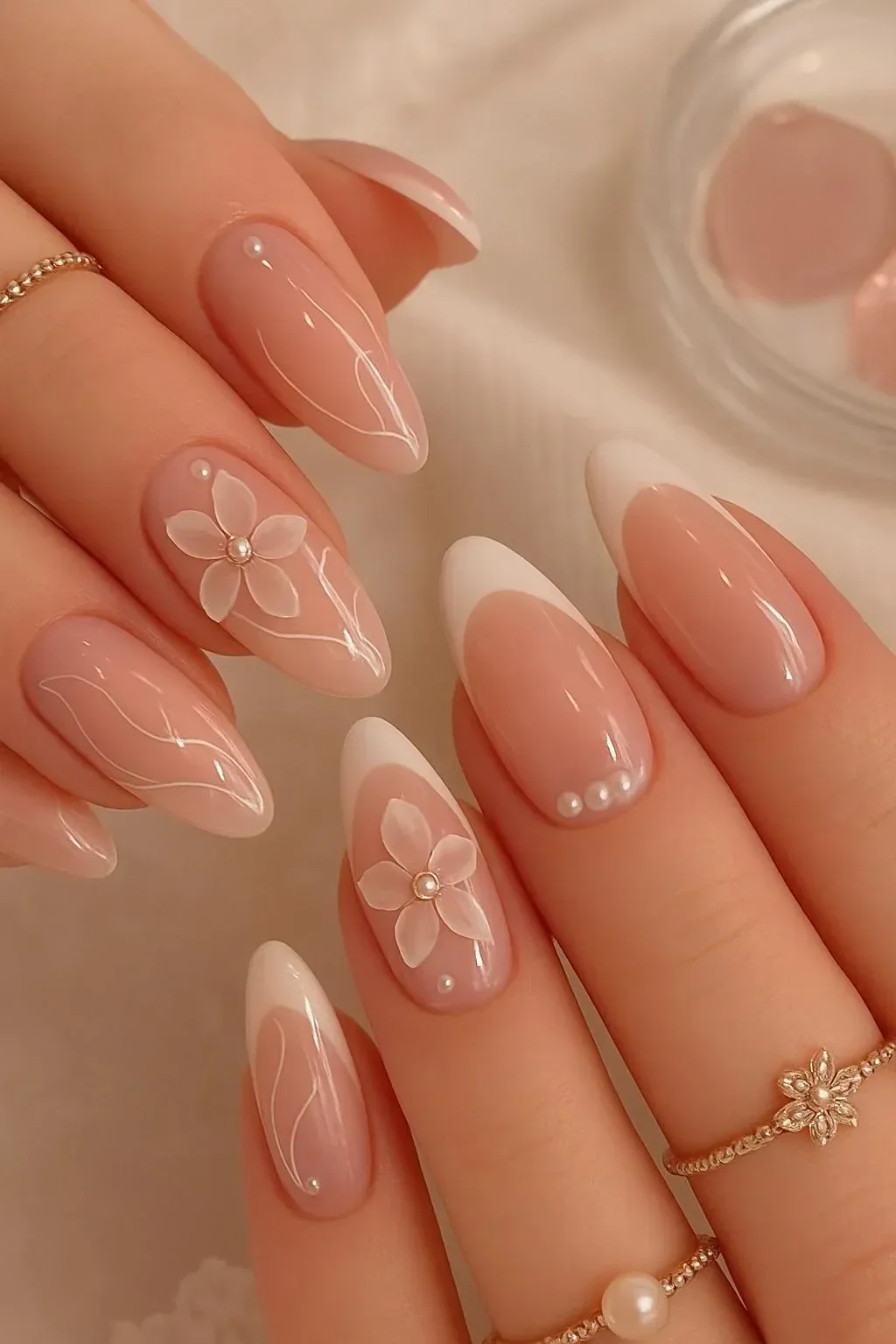 Aesthetic pink floral nail art design on elegant nude nails.