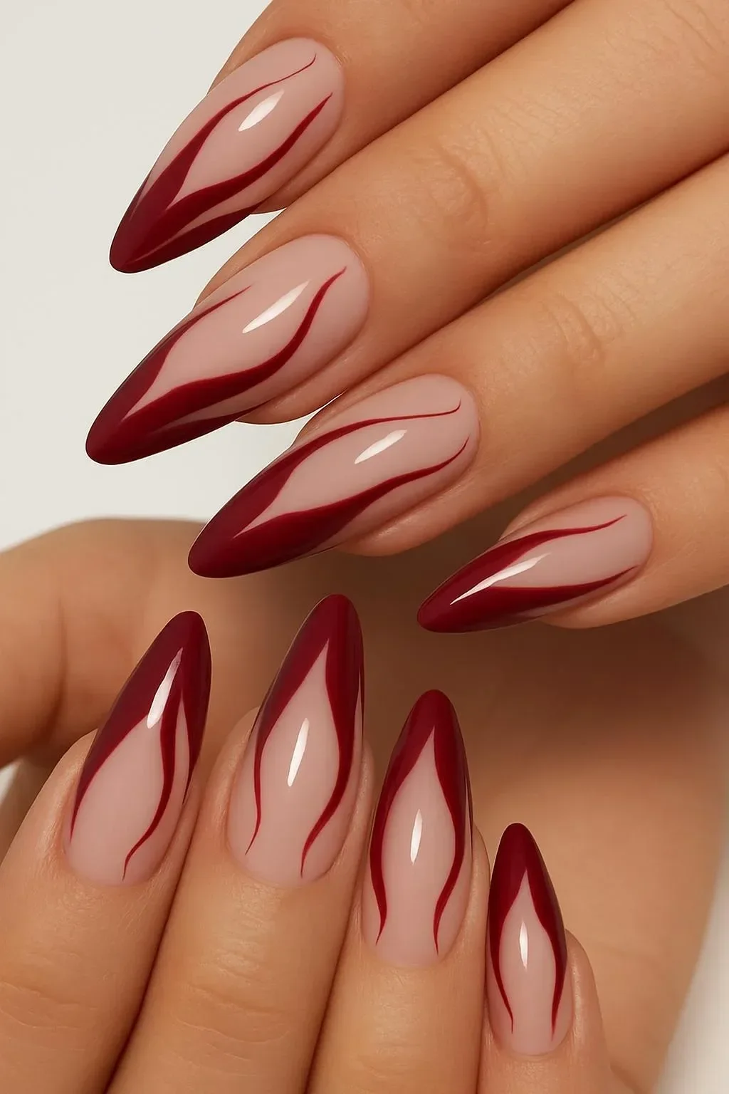 Burgundy winter nails featuring flame-tipped designs for a bold 2025 style.