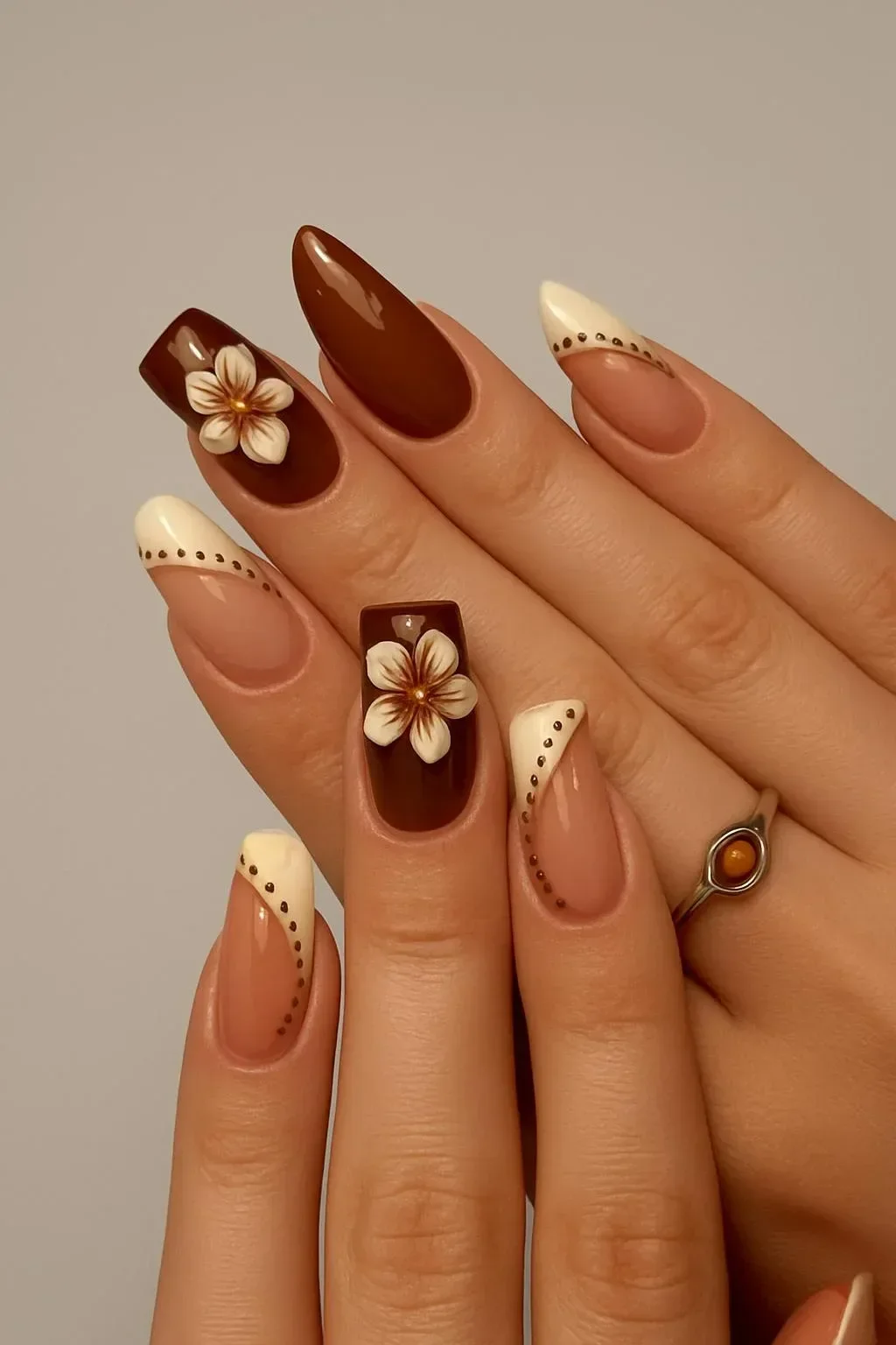 Brown floral press-on nails in coffin shape for autumn style.