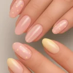Pastel pink and yellow French tip press on nails with polka dot stripe design