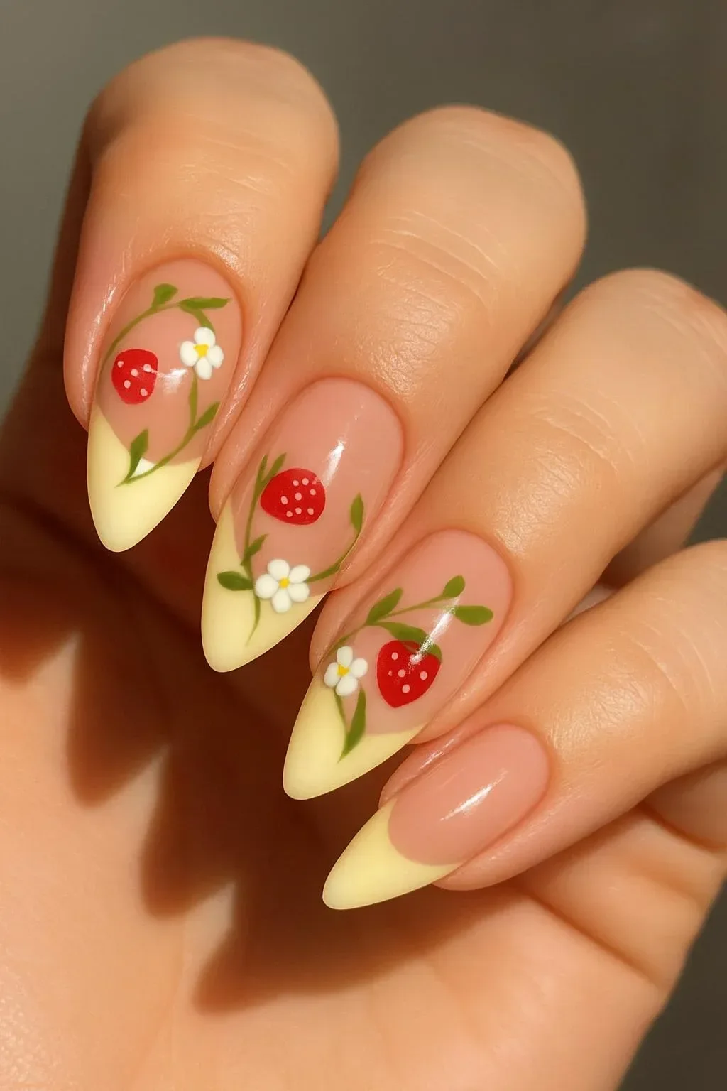 Strawberry garden nail art with almond-shaped nails and 3D accents of strawberry and ladybug.