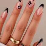 French Almond featuring elegant black tips and beautiful floral details.