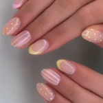 Colorful polka dot nail art design on a woman's nails showcasing a trendy pattern