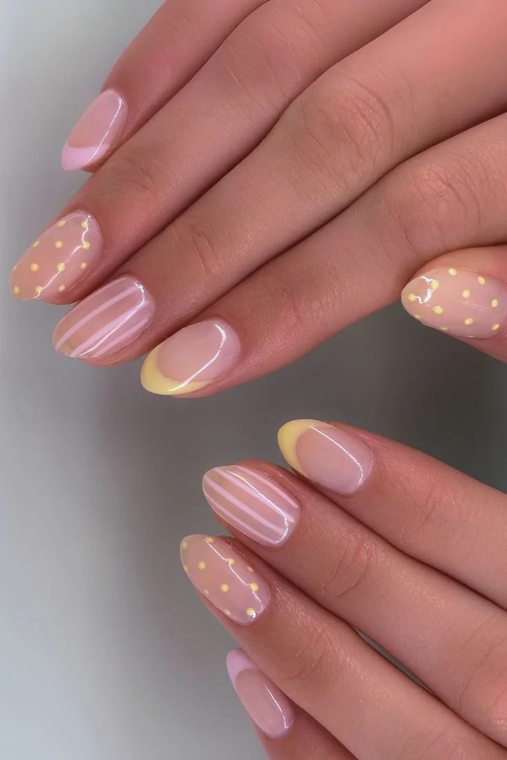 Colorful polka dot nail art design on a woman's nails showcasing a trendy pattern
